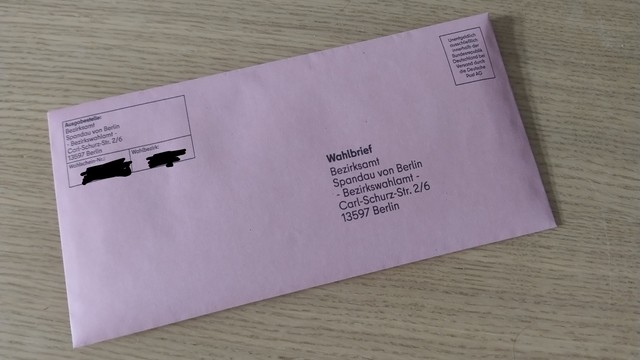 A closed pink envelope - Wahlbrief - containing the ballot.